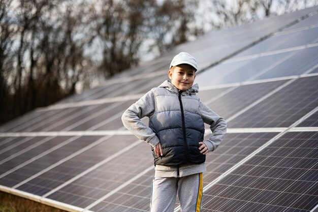 Boy child on the background of solar panels Eco energy