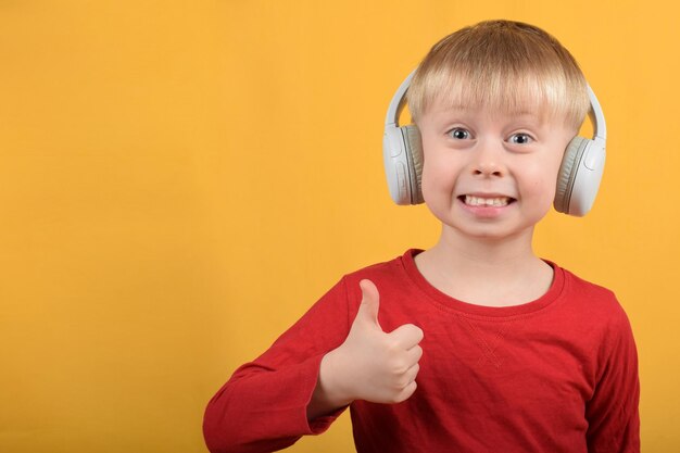 boy child enjoys music in headphones