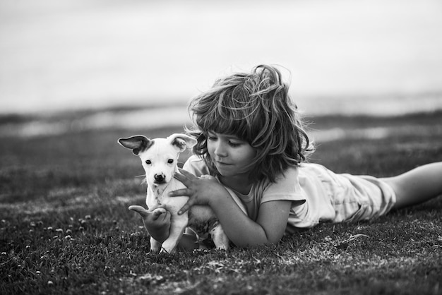 Boy child walk with puppy Portrait kid boy with little dog