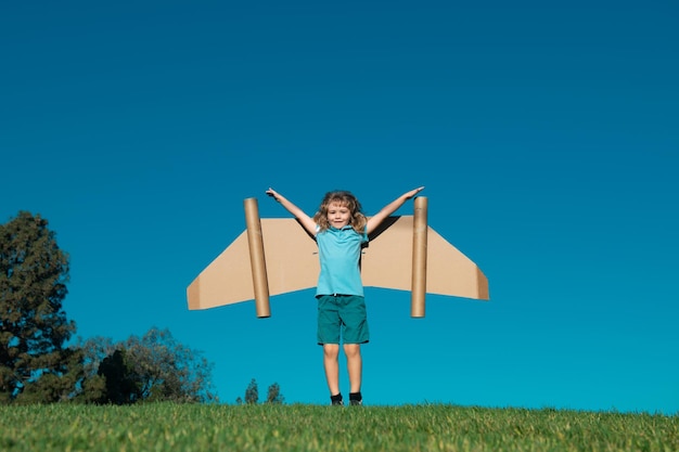Boy child with wings at sky imagines a pilot and dreams of flying kids adventure children freedom an