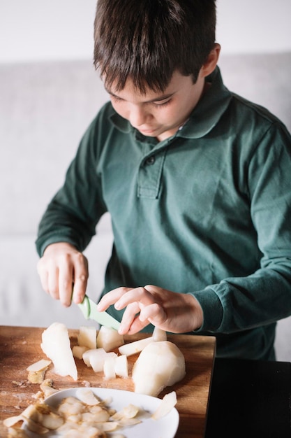 Boy chopping pear