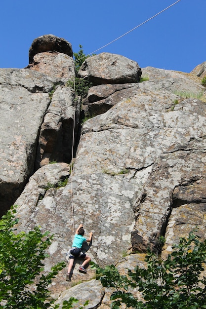 Boy climbing on the rock