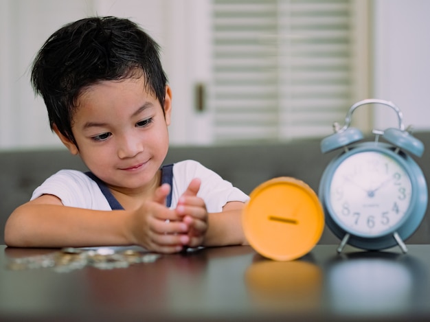 Boy collecting money or counting his savings