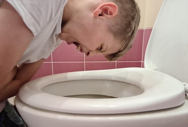 Boy in crouched and vomited into toilet pain in abdomen