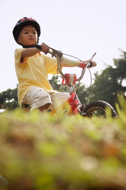 boy cycling at park