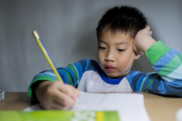 boy doing homework child writing paper education concept back to school