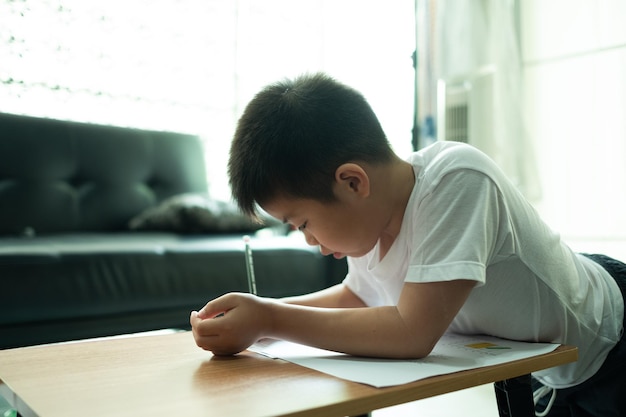 boy doing homework child writing paper education concept back to school