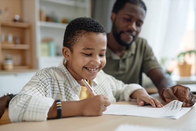 Boy doing homework with father