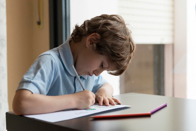 boy drawing on paper