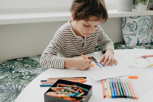 the boy draws with felt-tip pens high quality photo