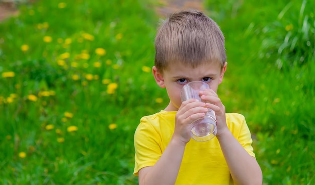 The boy drinks water from a glass Pure water Summer