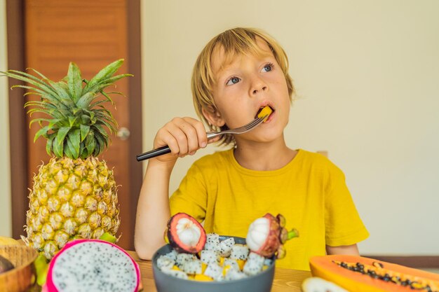 Boy eats fruit Healthy food for children Child eating healthy snack Vegetarian nutrition for kids Vitamins for children