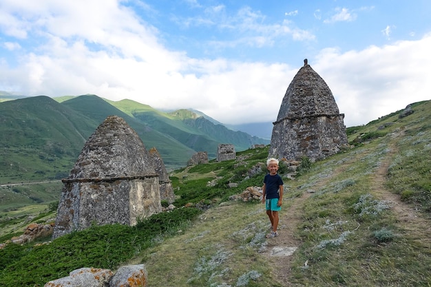 The boy in Eltyubyu is the city of the dead Ancient stone crypts in KabardinoBalkaria Russia 2021