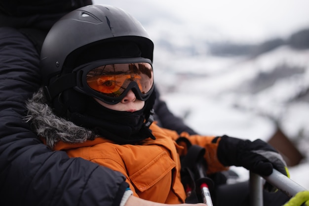 A boy in equipment is skiing on a snowy slope