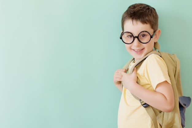 Boy in eyeglasses with school backpack