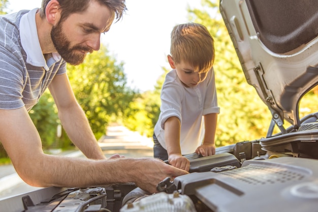 車を修理する少年と父親