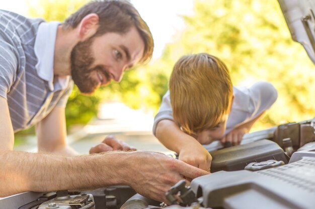 車を修理する少年と父親