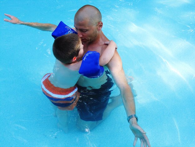 Photo boy and father in water