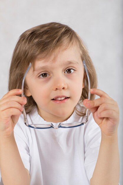 Boy of five years old in eyeglasses. Closeup