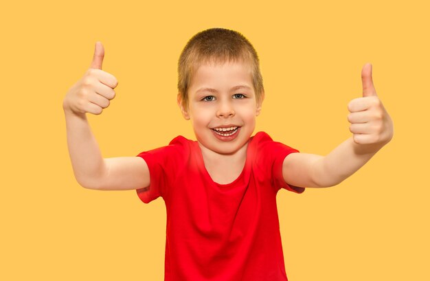 A boy fiveyearold child very cheerful smiling emotionally and showing a thumbs up