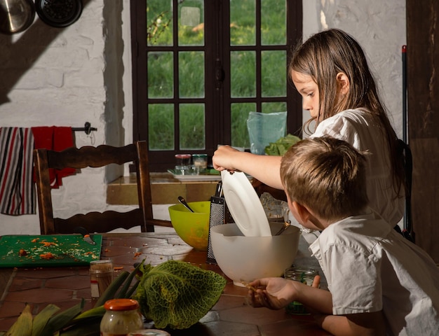 Boy and girl cooking in the kitchen real photo