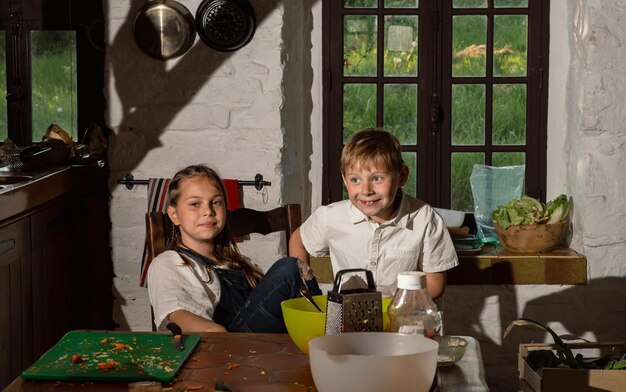 Boy and girl cooking in the kitchen real photo