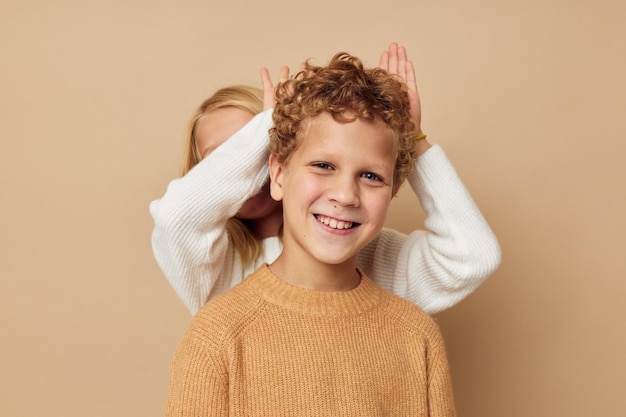 Boy and girl gesticulate with their hands together Lifestyle unaltered