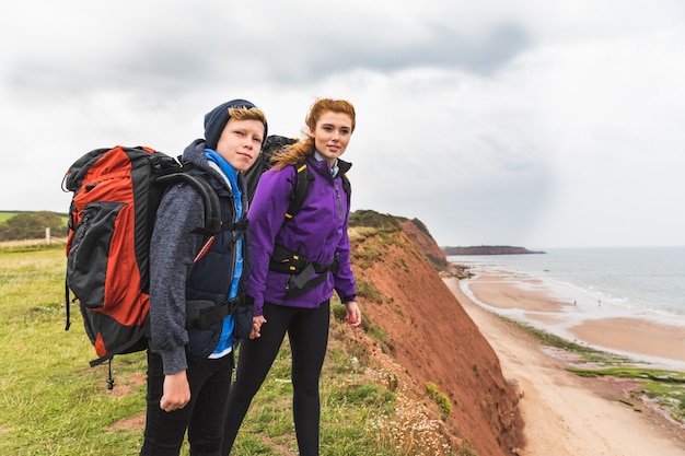 Boy and girl hiking and looking at view