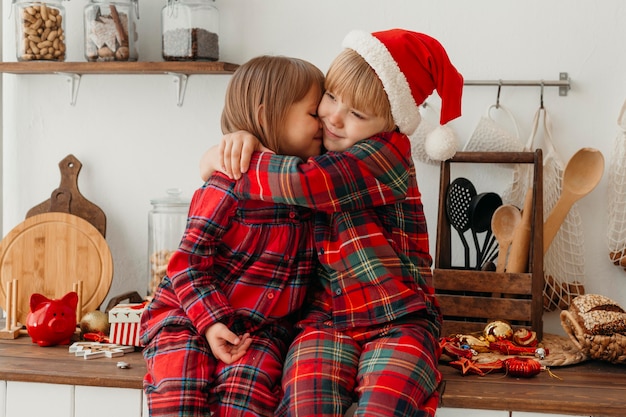 Boy and girl hugging on christmas day