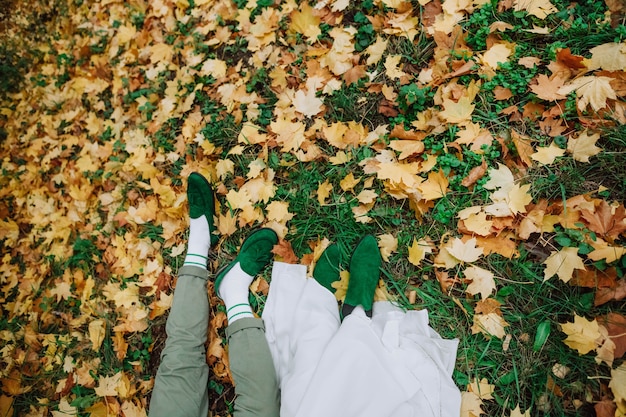 Boy girl lie autumn green shoes