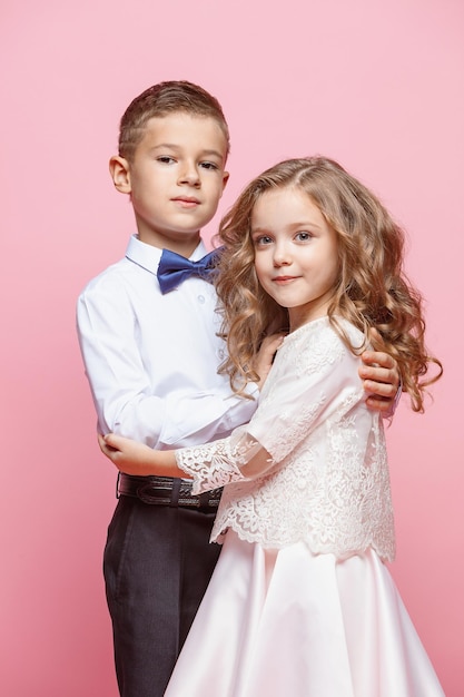 Boy and girl standing and posing in studio