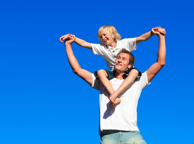 Boy giving kid a piggyback ride