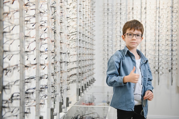 Boy in glasses at optics store