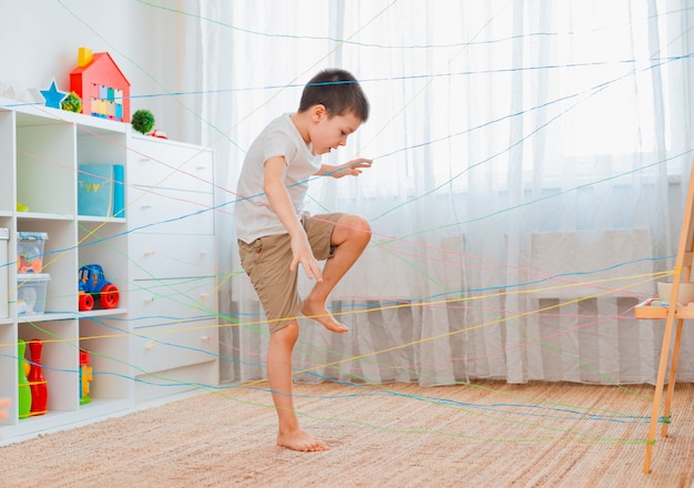 Boy going through a rope web