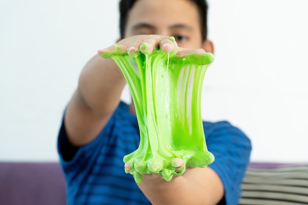 Photo boy hand holding homemade toy called slime
