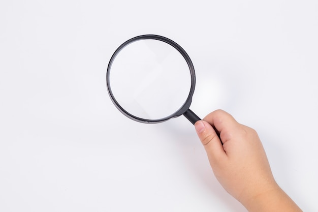 Boy hand with magnifying glasses