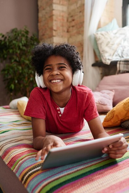 Boy having fun at home with tablet pc