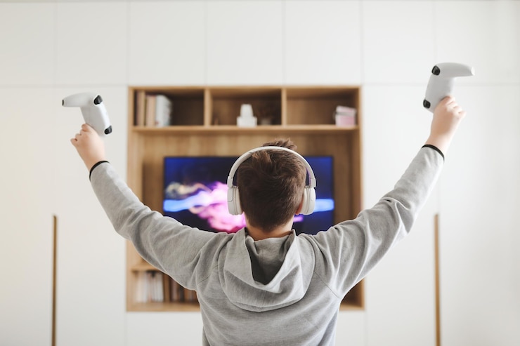 फोटो boy in headphones watching television teenager boy playing video game in front of screen at home