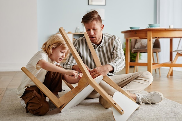 Boy Helping Dad Building Furniture