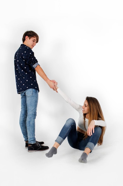 Boy helping girl to get up