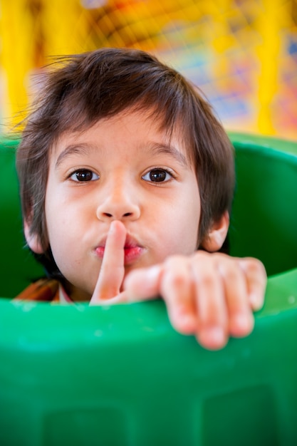 Boy hiding in a plastic barrel