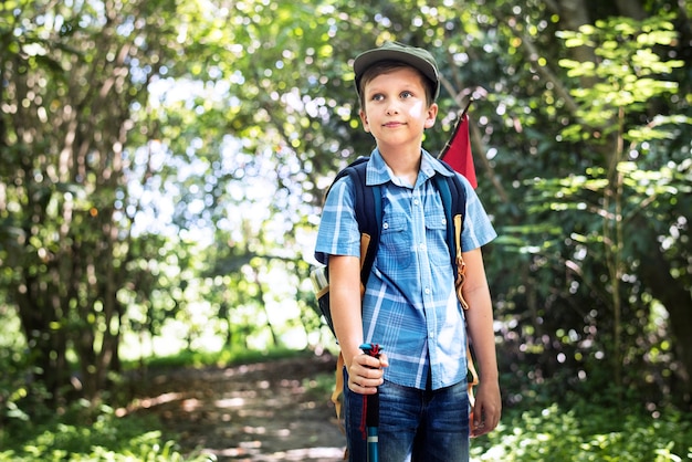 Boy hiking through a forest