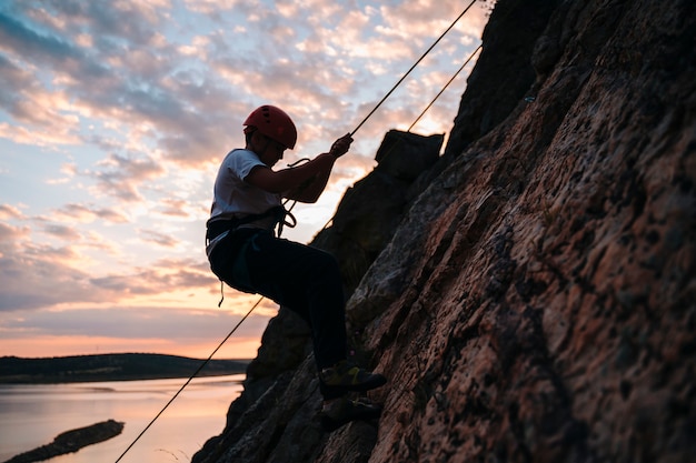 Boy in his 10s coming down from a mountain at sunset