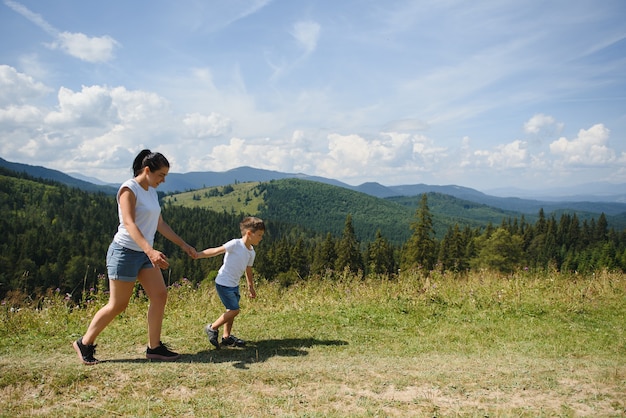 Boy and his mother standing on a mountain