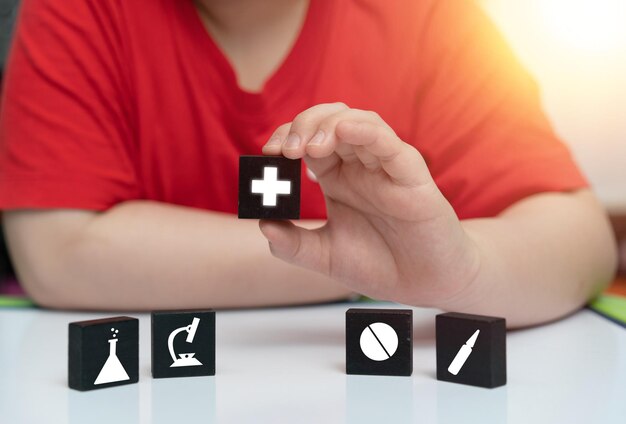 Boy hold cube that have mecical healthcare sign