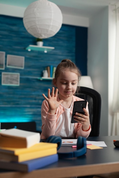 Photo boy holding mobile phone at home