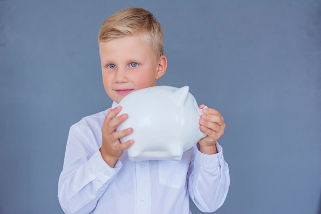 Boy holding a piggy bank in his hands bank saving money bank investment