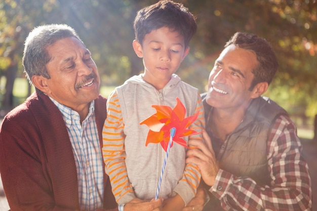 Boy holding pinwheel toy with family