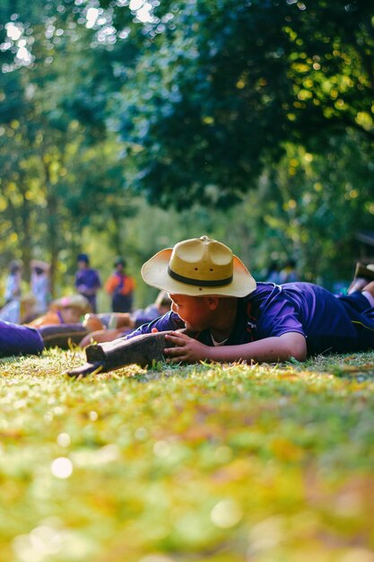 Boy holding toy while lying down on land