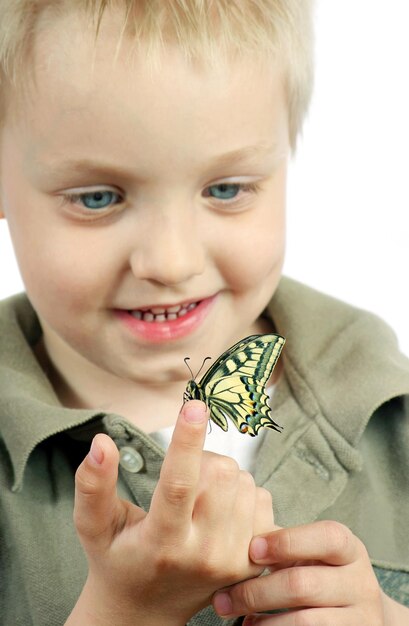 a boy holds a butterfly that has the word butterfly on it